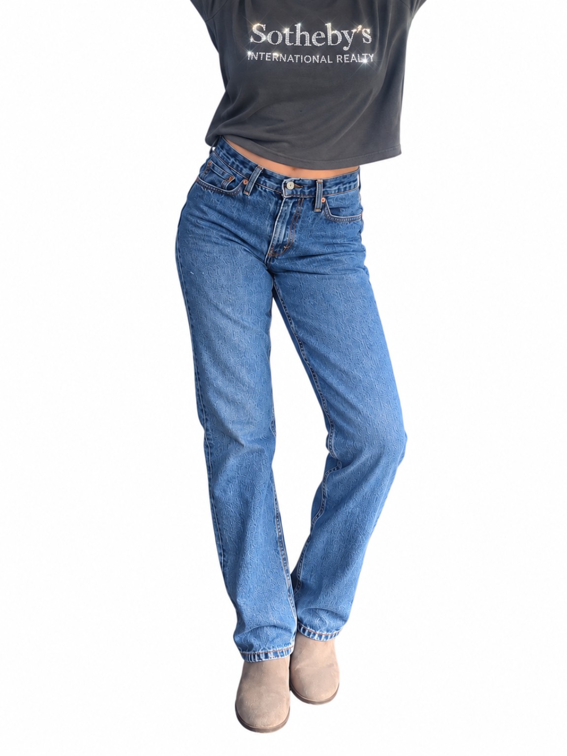 Charcoal Low-Key Luxe tee styled with blue jeans, featuring the sparkling Sotheby’s International Realty crystal logo